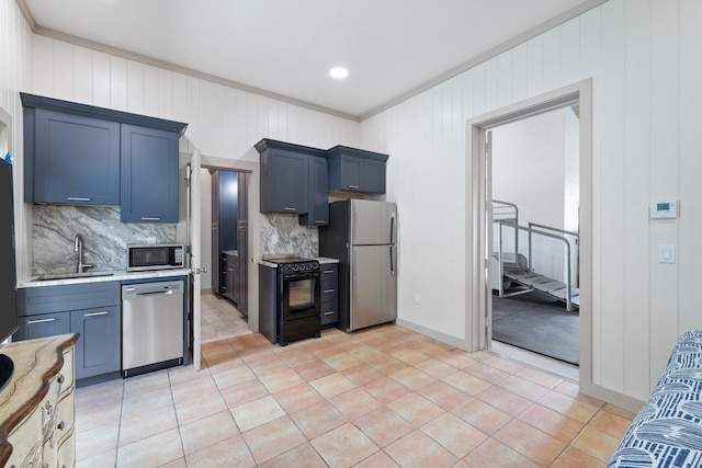 kitchen featuring tasteful backsplash, appliances with stainless steel finishes, and wood walls