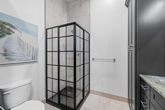 bathroom featuring vanity, toilet, and tiled shower