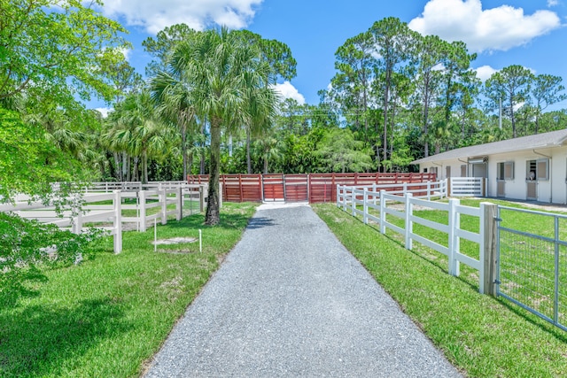 view of gate with a lawn