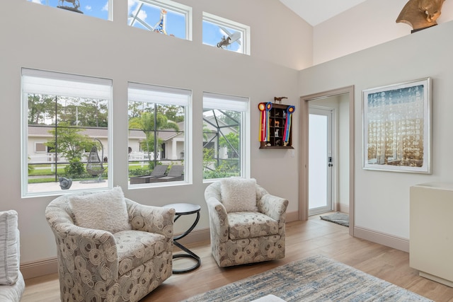 1464 Stallion Dr, Loxahatchee, FL 33470 - living area with light wood-type flooring, a high ceiling, and baseboards
