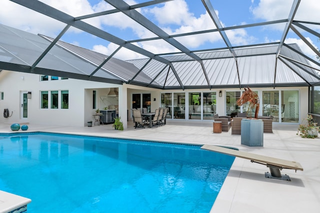 back of house with a patio and glass enclosure