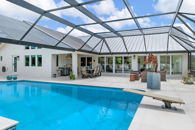 1464 Stallion Dr, Loxahatchee, FL 33470 - swimming pool with a patio, outdoor dining space, a diving board, and glass enclosure