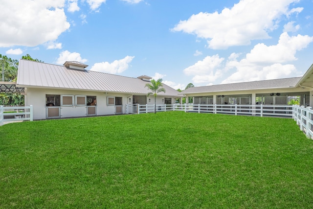 back of house with a lawn