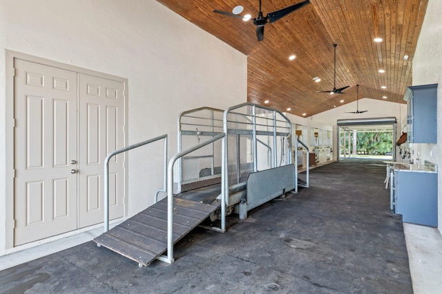 interior space with concrete floors, wood ceiling, high vaulted ceiling, and ceiling fan