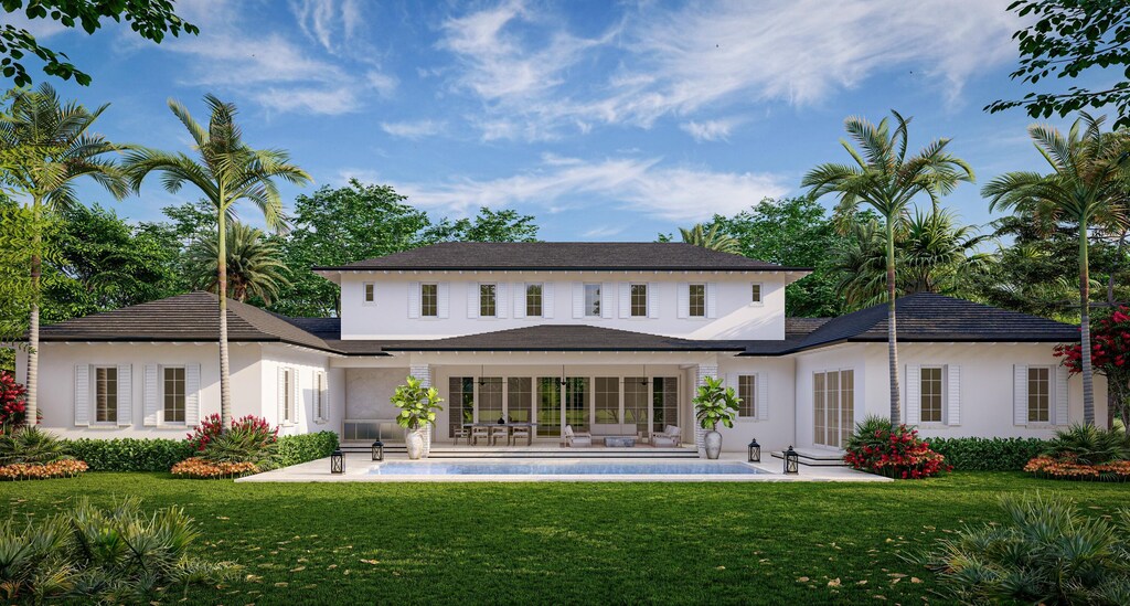 rear view of house featuring a patio area, stucco siding, and a lawn