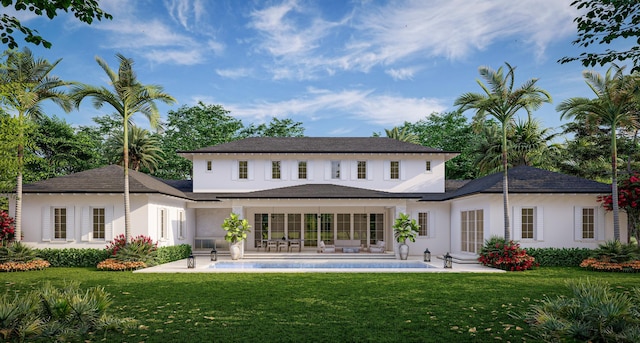 rear view of house featuring a patio area, stucco siding, and a lawn