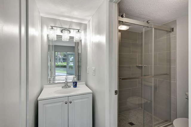 3200 SE Aster Ln Unit S-102, Stuart, FL 34994 - bathroom with a stall shower, vanity, a textured ceiling, a chandelier, and toilet