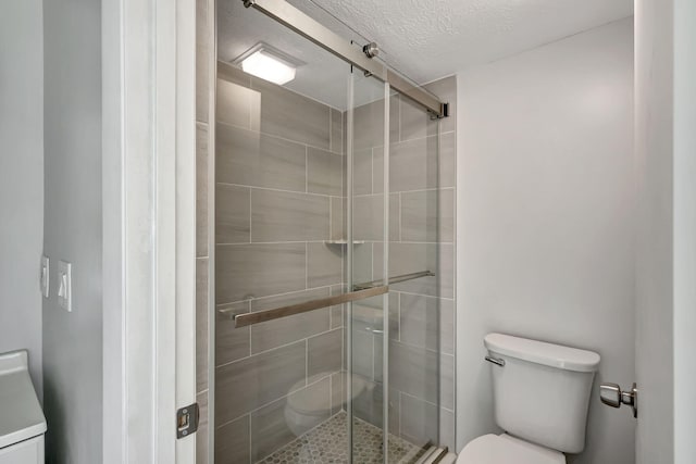 3200 SE Aster Ln Unit S-102, Stuart, FL 34994 - full bath with toilet, a shower stall, and a textured ceiling
