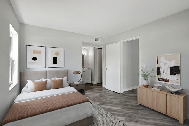 walk in closet with dark wood-type flooring