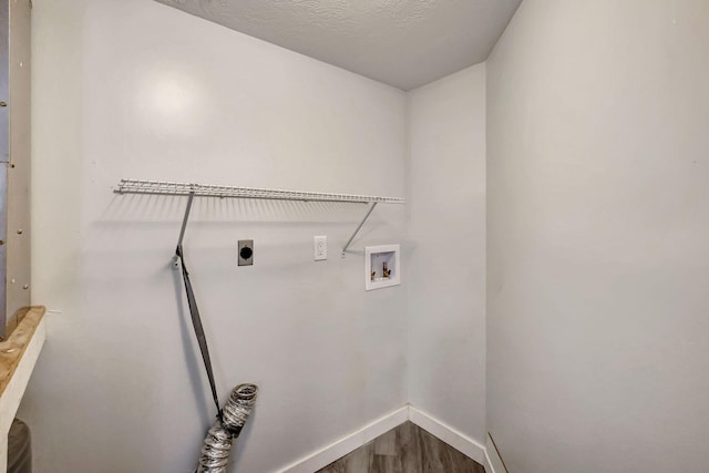 3200 SE Aster Ln Unit S-102, Stuart, FL 34994 - laundry room with hookup for an electric dryer, washer hookup, dark wood-style floors, and baseboards