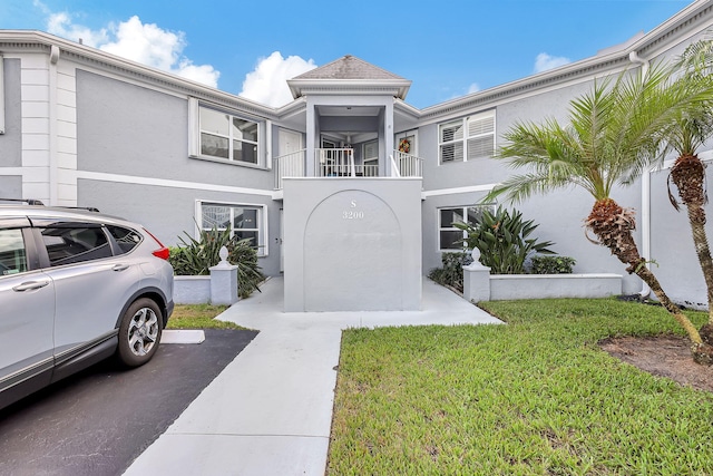 3200 SE Aster Ln Unit S-102, Stuart, FL 34994 - multi unit property featuring stucco siding, a balcony, and a front yard