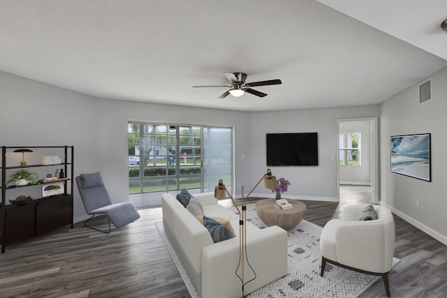 3200 SE Aster Ln Unit S-102, Stuart, FL 34994 - living area featuring wood finished floors, a ceiling fan, and baseboards