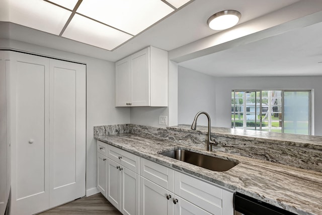 kitchen featuring white cabinets, light stone counters, and stainless steel appliances