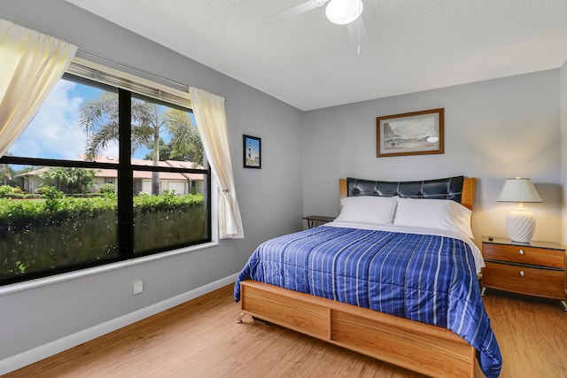 bedroom featuring a textured ceiling, hardwood / wood-style flooring, and ceiling fan