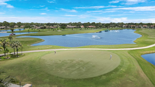 surrounding community featuring a water view and a lawn