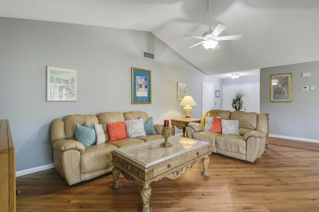 living room with ceiling fan, hardwood / wood-style flooring, and vaulted ceiling