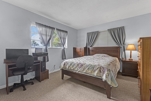 bedroom with baseboards, carpet flooring, and a textured ceiling