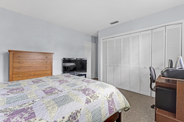 bedroom featuring visible vents, carpet, and a closet