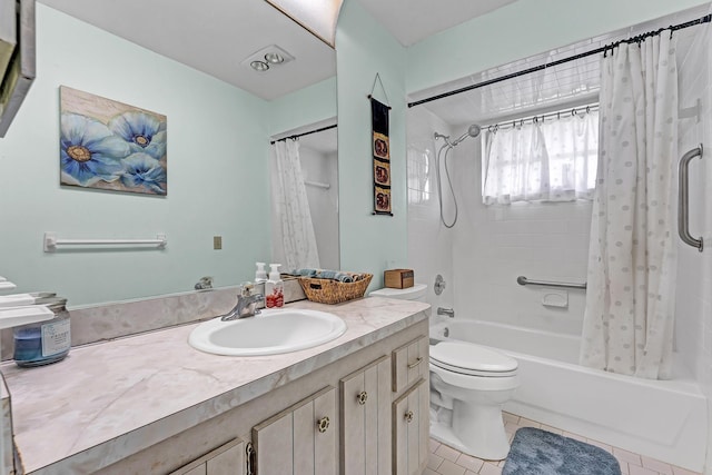 full bath featuring tile patterned floors, shower / bath combo with shower curtain, vanity, and toilet