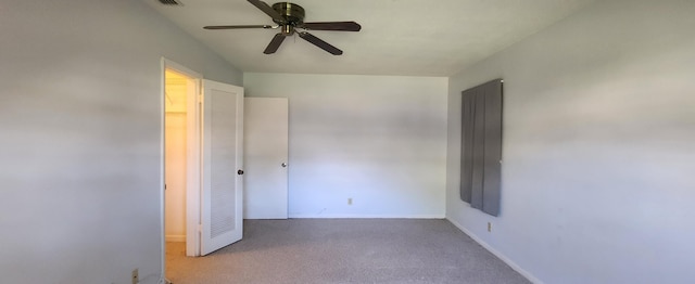 unfurnished bedroom with carpet flooring, a ceiling fan, and baseboards