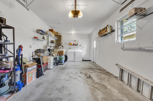 garage with washer and clothes dryer and a garage door opener