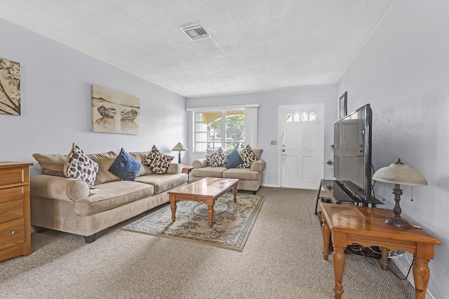 carpeted living room featuring a textured ceiling