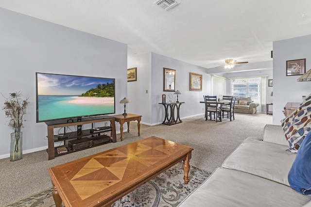 living room featuring ceiling fan and carpet