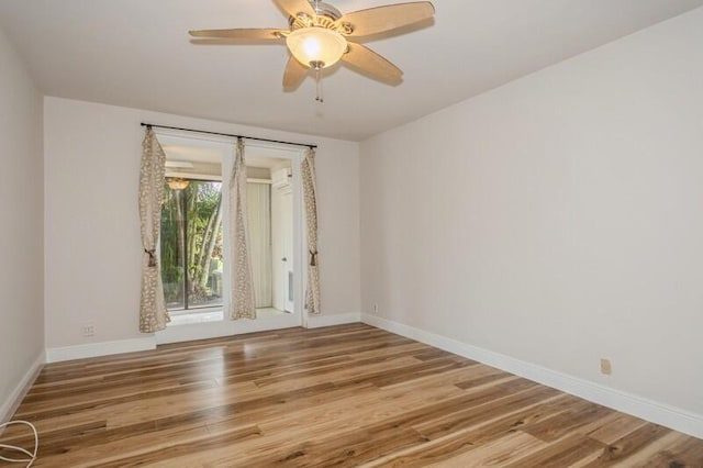 empty room featuring hardwood / wood-style flooring and ceiling fan