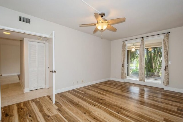 unfurnished room with ceiling fan and hardwood / wood-style flooring