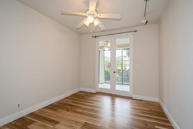 unfurnished room with french doors, light wood-type flooring, and ceiling fan