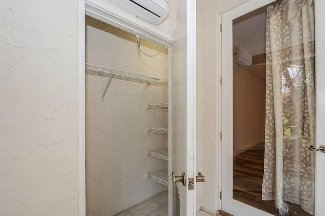 closet with a wall mounted air conditioner