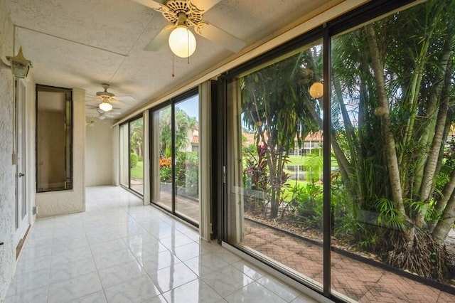 entryway with ceiling fan and light tile patterned flooring