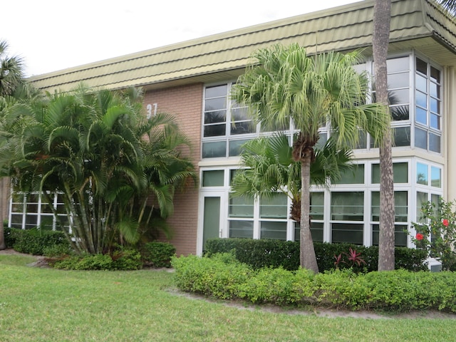 view of home's exterior with a yard