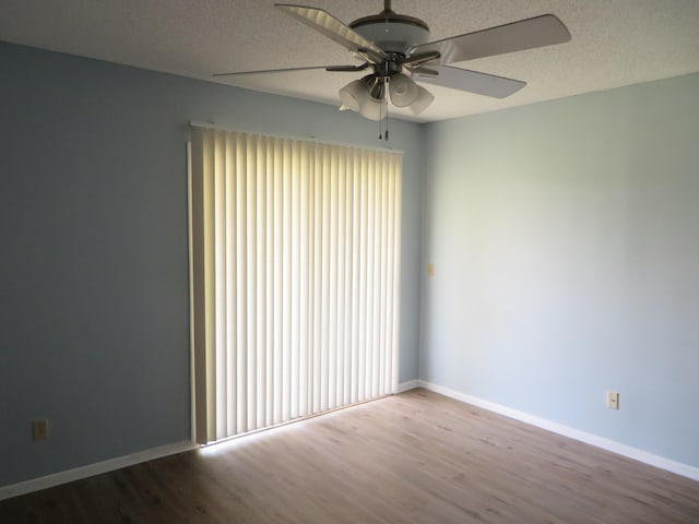 empty room featuring ceiling fan, light hardwood / wood-style floors, and a textured ceiling