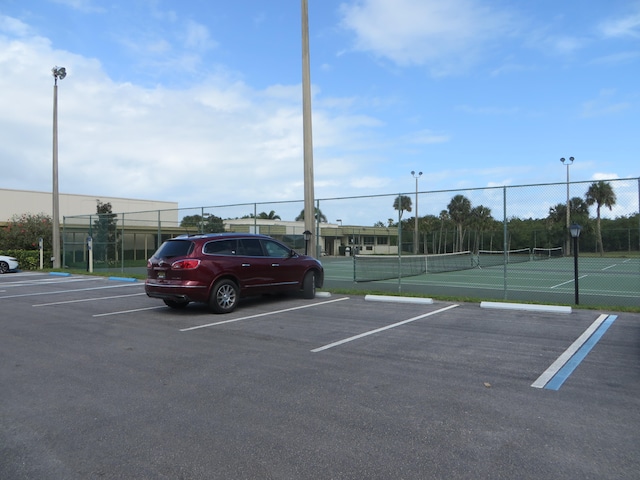 view of parking with tennis court