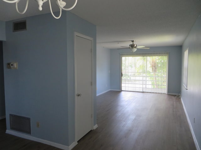 spare room featuring dark hardwood / wood-style flooring and ceiling fan