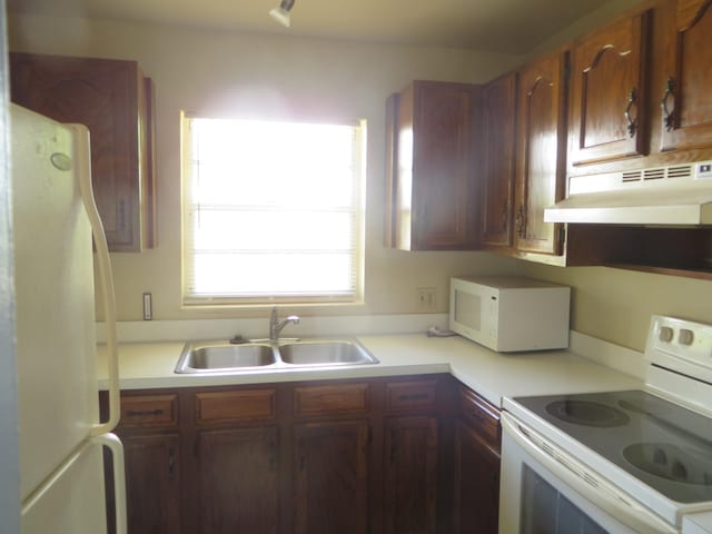 kitchen with sink and white appliances