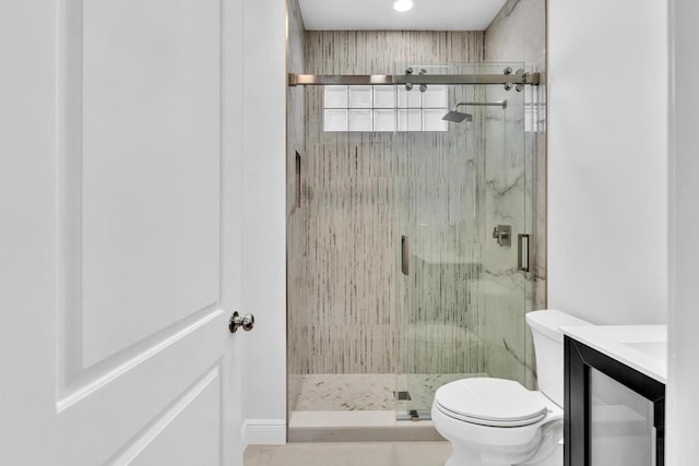 bathroom featuring vanity, tile patterned floors, toilet, and an enclosed shower