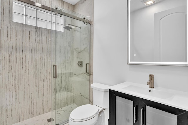 bathroom featuring toilet, an enclosed shower, and vanity