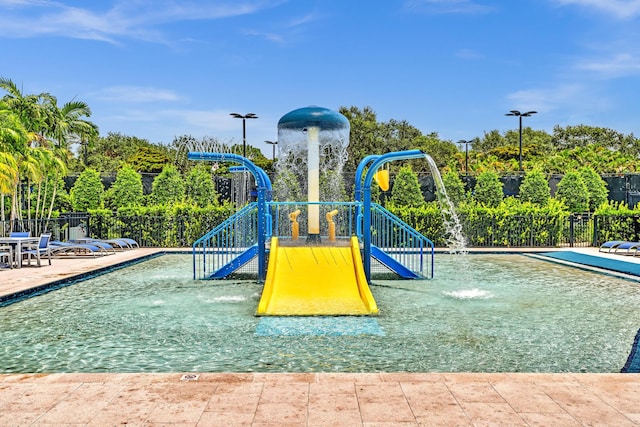 view of play area with pool water feature and a community pool