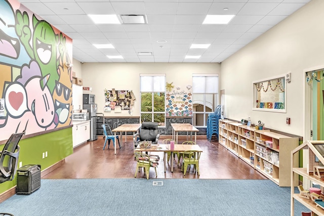 rec room featuring a drop ceiling and dark hardwood / wood-style flooring