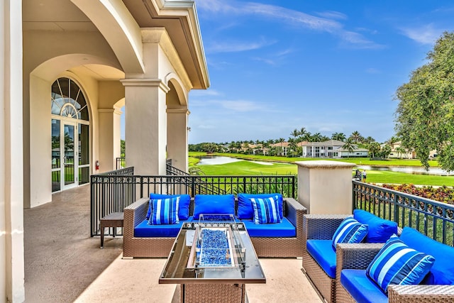 view of patio with an outdoor living space with a fire pit