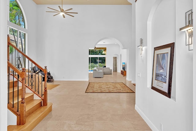 foyer featuring a high ceiling and ceiling fan