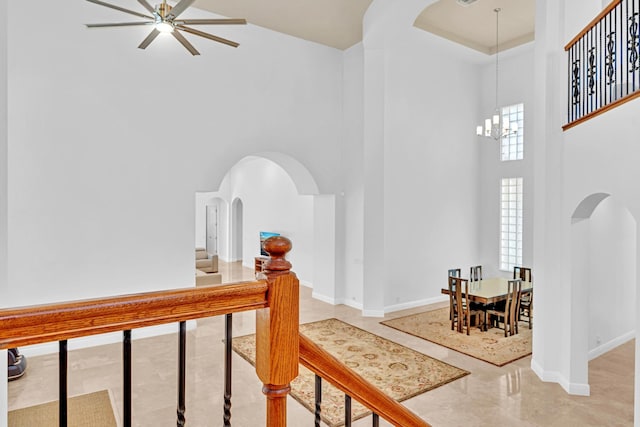 hall featuring a high ceiling and an inviting chandelier