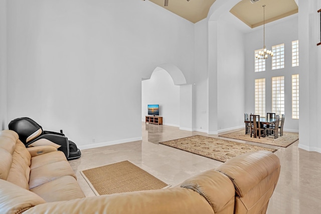 living room featuring a high ceiling and a chandelier