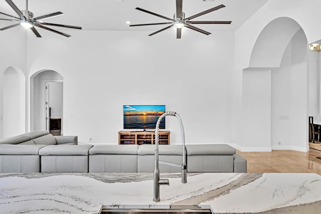 tiled living room with sink and ceiling fan