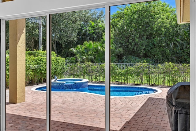 view of swimming pool with a patio area and an in ground hot tub