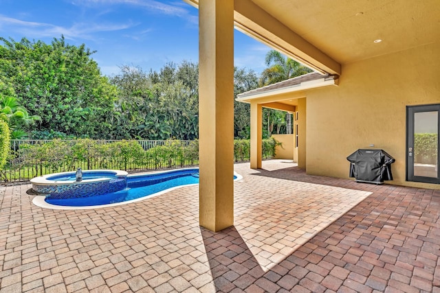 view of swimming pool with an in ground hot tub, grilling area, and a patio