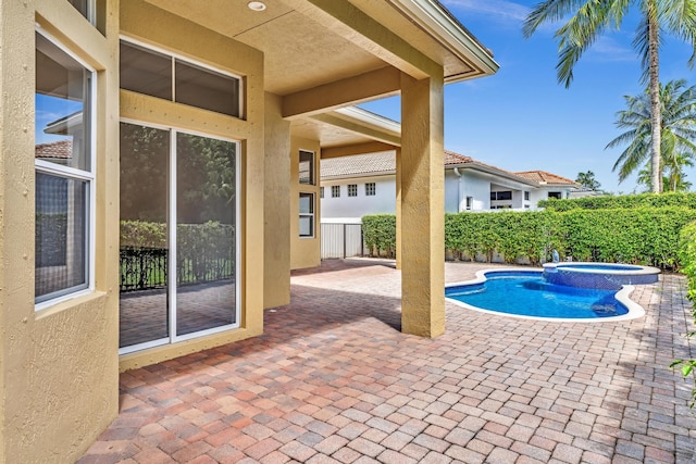 view of swimming pool with an in ground hot tub and a patio