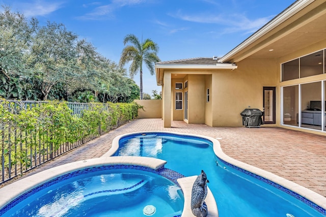 view of swimming pool featuring an in ground hot tub and a patio